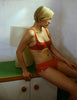 A model wearing the Gal Hip Hugger in bright orange silk