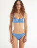 a model in the gita underwire bra and gwyneth panty in darling blue