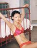 woman wearing red/pink willow bralette by bed 